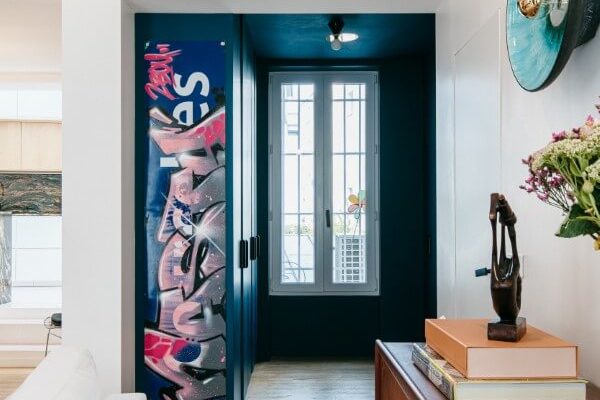 Entrée d'appartement monochrome avec une oeuvre de street art